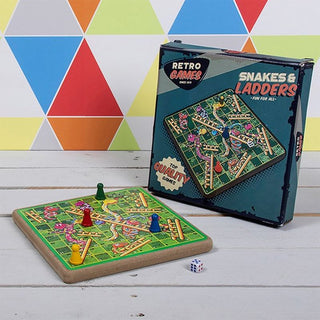 Retro Games Snakes and Ladders board game set with colourful playing tokens and a dice on a white wooden table.